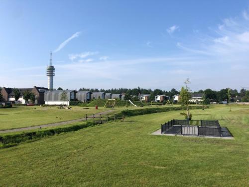 a field with a park with a playground at B&B Mir Lo in Mierlo Adults only in Mierlo