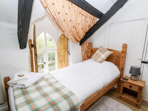 a bedroom with a bed and a window at Maesgwyn in Cardigan