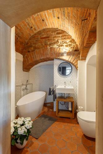 a bathroom with a large tub and a sink at Apartments No 126 Loket in Loket