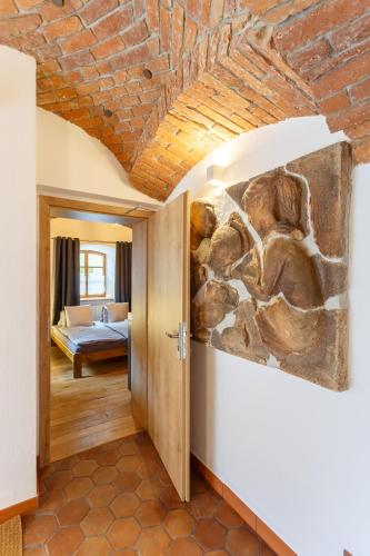 a painting on the wall of a room with a bed at Apartments No 126 Loket in Loket