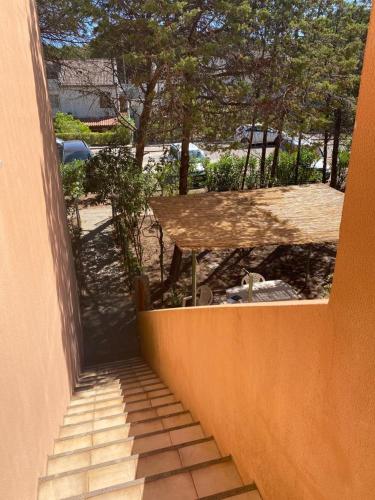 a stairway leading up to a house with a table at Arboria Sun & Sea in Sorso