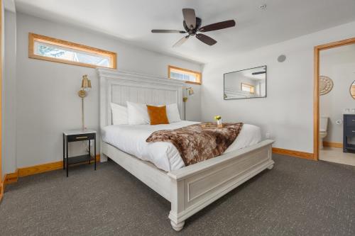 a bedroom with a white bed and a ceiling fan at Ocean House in Newport