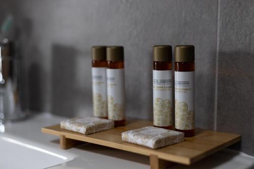 a group of three bottles of spices on a wooden shelf at Abraços dos Avós - Casas de aldeia in Viana do Castelo