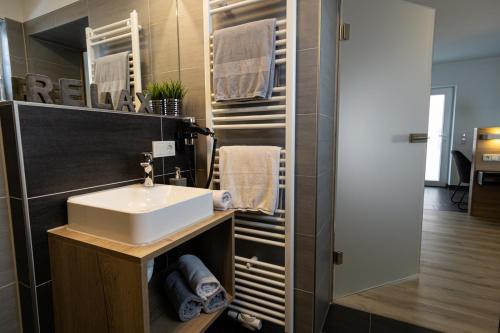 a bathroom with a sink and a mirror at Ferienwohnung Dorfbrunnen in Merzig