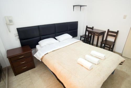 a bedroom with a large bed with two pillows on it at Hostal Sueños Breña in Lima