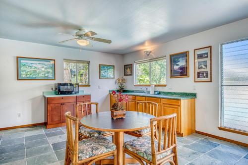 a dining room with a table and chairs and a kitchen at Kona Kanewa Home in Kailua-Kona
