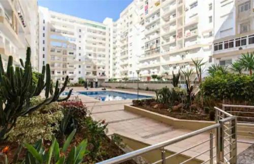 a large apartment complex with a swimming pool and buildings at nice little apartment with swimming pool in Agadir
