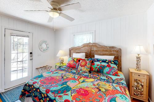 a bedroom with a bed and a ceiling fan at All Decked Out in Edisto Beach