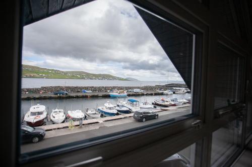a window view of a marina with boats in the water at Unique Boathouse - Central - Kajak - Fitness in Strendur