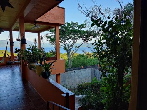 a balcony of a house with plants on it at Posada Los Chaneques Catemaco in Catemaco