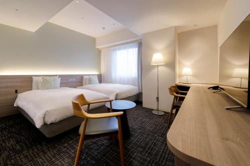 Postel nebo postele na pokoji v ubytování Glocal Hotel Itoshima