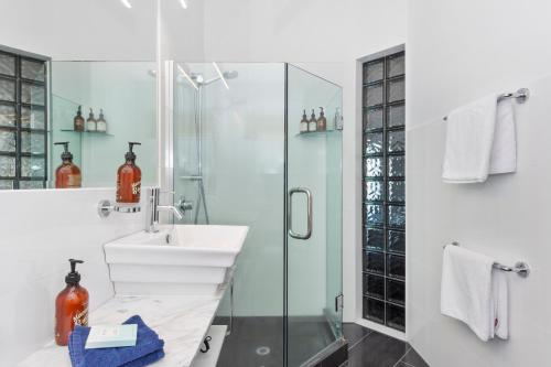 a bathroom with a sink and a shower at The Tauranga on the Waterfront in Tauranga
