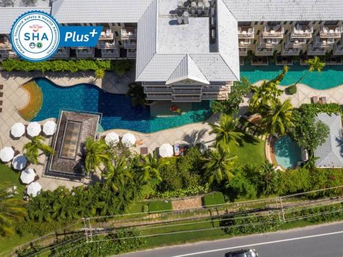 an aerial view of a resort with a swimming pool at The Front Village - SHA Plus in Karon Beach
