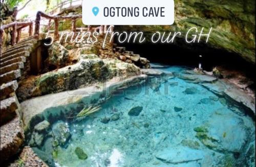 a swimming pool in a cave with the words os operating cave miles from our at Paradise Beach Guest House in Bantayan Island