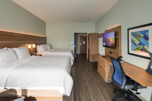 a hotel room with two beds and a desk at Holiday Inn Express & Suites - Charlotte - South End by IHG in Charlotte
