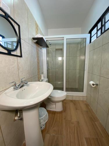 a bathroom with a sink and a toilet at Micro Hotel Express in San Pedro Sula