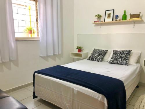 a bedroom with a bed with two pillows on it at Casa com ótima localização in Piracicaba