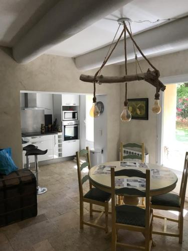 a kitchen with a table and chairs in a room at Le jardin in Aix-en-Provence