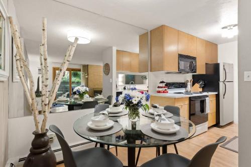 a kitchen and dining room with a glass table and chairs at Sagewood 8 in Aspen