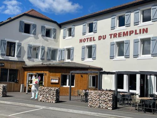 a person standing in front of a hotel durham at Hôtel Restaurant & Spa du Tremplin in Bussang