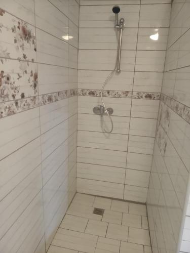 a bathroom with a shower with a tiled shower at chata FRIDAY in Ktová