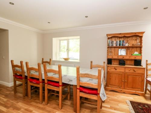 a dining room with a table and chairs at Tigh Na Drochit in Garve