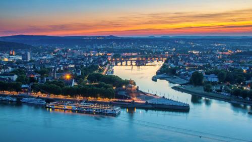 a view of a river with a city at dusk at Lindenhof in Osterspai