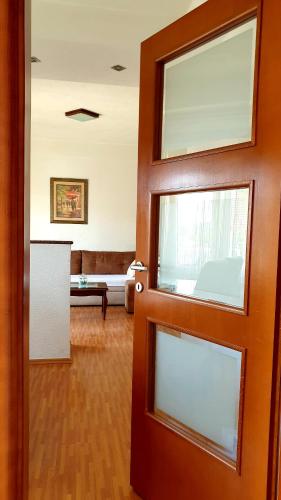 a door leading to a living room with a couch at Apartman Ćorić Posušje in Posušje