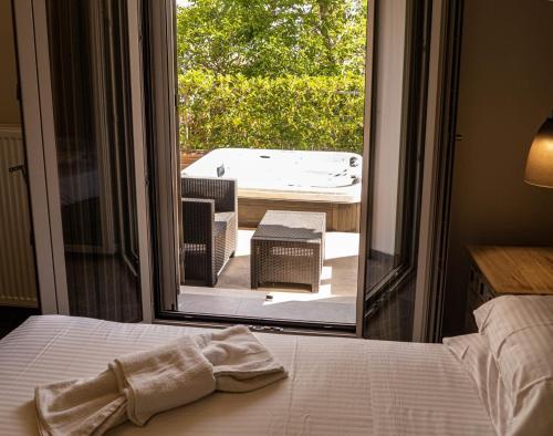 a bed in a room with a view of a patio at Karya Villas in Kariá