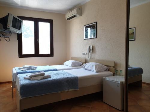 Postel nebo postele na pokoji v ubytování Hotel Pelikan