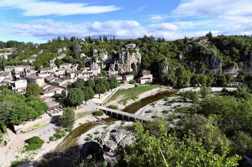 an aerial view of a small town with a mountain at Le Bruit de l'eau (Chambre Boudoir) in Labeaume
