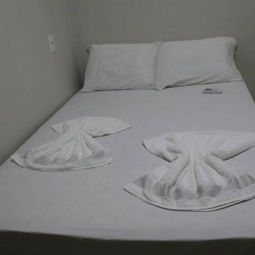 a white bed with two towels on top of it at Hospedagem nascentes do jalapao in Mateiros