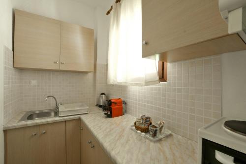 a kitchen with a sink and a counter top at Galini Apartments in Achlia
