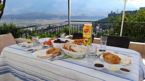 a table with plates of food on it with a view at Inn Cloud Gjirokaster in Gjirokastër