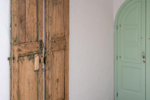 a wooden door in a room with a doorway at Dipagio Origin Villa in Lachania
