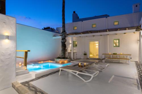 a villa with a swimming pool and a patio at Dipagio Origin Villa in Lachania