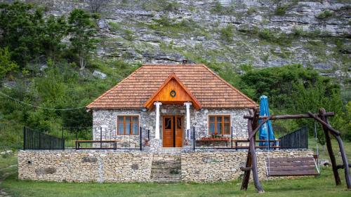 a small house with a playground in front of it at Casa Agricultorului Varzari in Butuceni