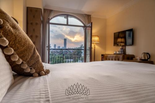 a bedroom with a large bed with a large window at The Grand Palace Hotel in Addis Ababa