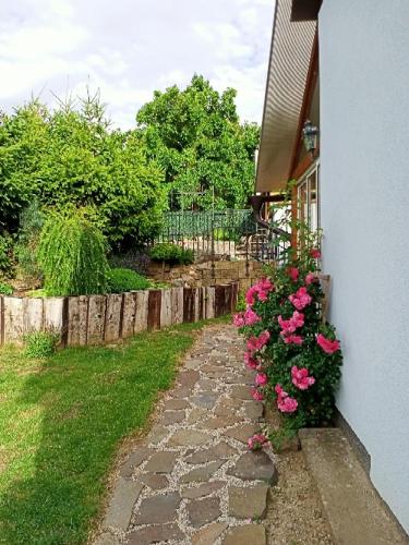 a garden with pink flowers next to a house at Ubytování v Tučapech 96 in Boršice