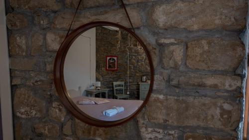 a mirror on a stone wall in a room at Il Rifugio di Bomar in Pietrapertosa