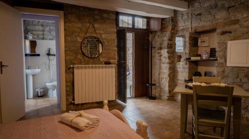a living room with a table and a room with a bathroom at Il Rifugio di Bomar in Pietrapertosa