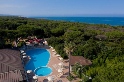 an aerial view of a resort with a swimming pool and the ocean at Park Hotel Marinetta - Beach & Spa in Marina di Bibbona
