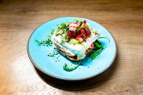 a blue plate with a piece of food on a table at Apartments Skadarlija in Belgrade
