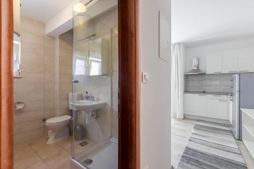 a bathroom with a toilet and a sink at Villa Stipe in Podstrana