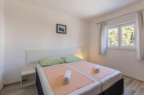 a bedroom with a large bed with a window at Villa Stipe in Podstrana