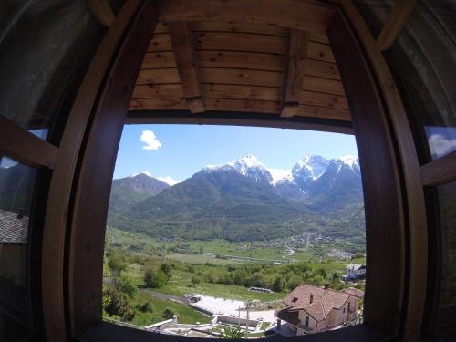 a view of a mountain range from a window at B&B La Mandorla in Quart