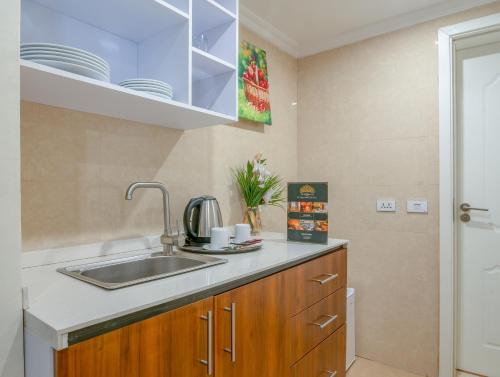 a kitchen with a sink and a counter top at The Grand Palace Hotel in Addis Ababa