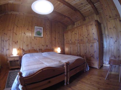 a bedroom with a bed in a wooden room at B&B La Mandorla in Quart