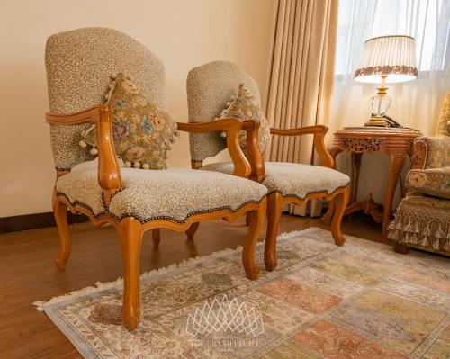 a couple of chairs sitting in a living room at The Grand Palace Hotel in Addis Ababa