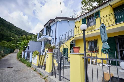 a yellow and blue building with a fence at Ca' de Paggia in Savona